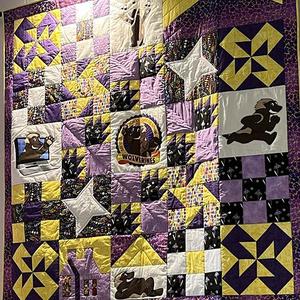 A purple and gold quilt.