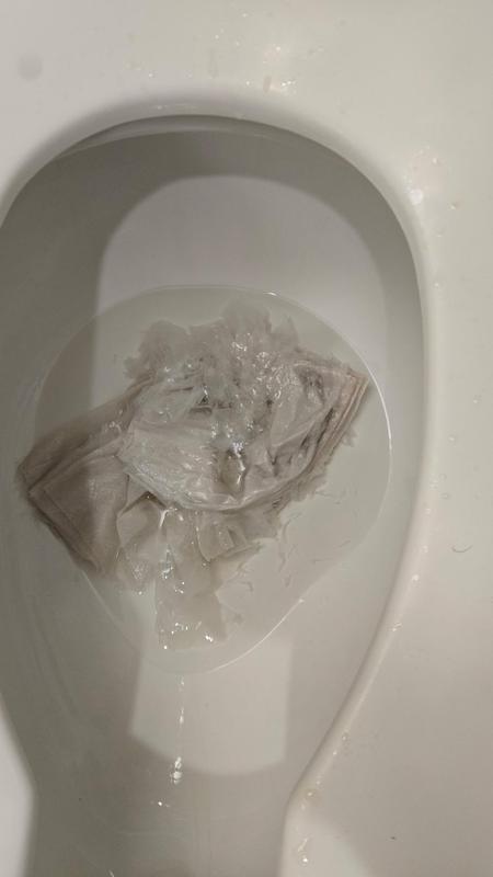 Toilet full of paper towels