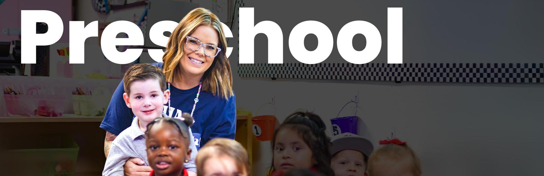 A preschool teacher smiling with a group of young children in a classroom at Alta Loma Christian School.