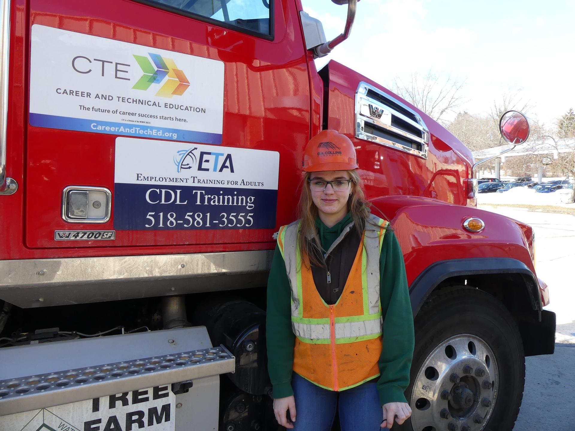 Amber Flynn next to dump truck