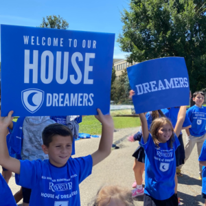 Students hold up House of Dreamers Signs