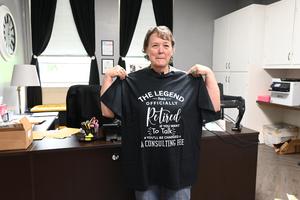Mrs. Smith holding up her shirt.