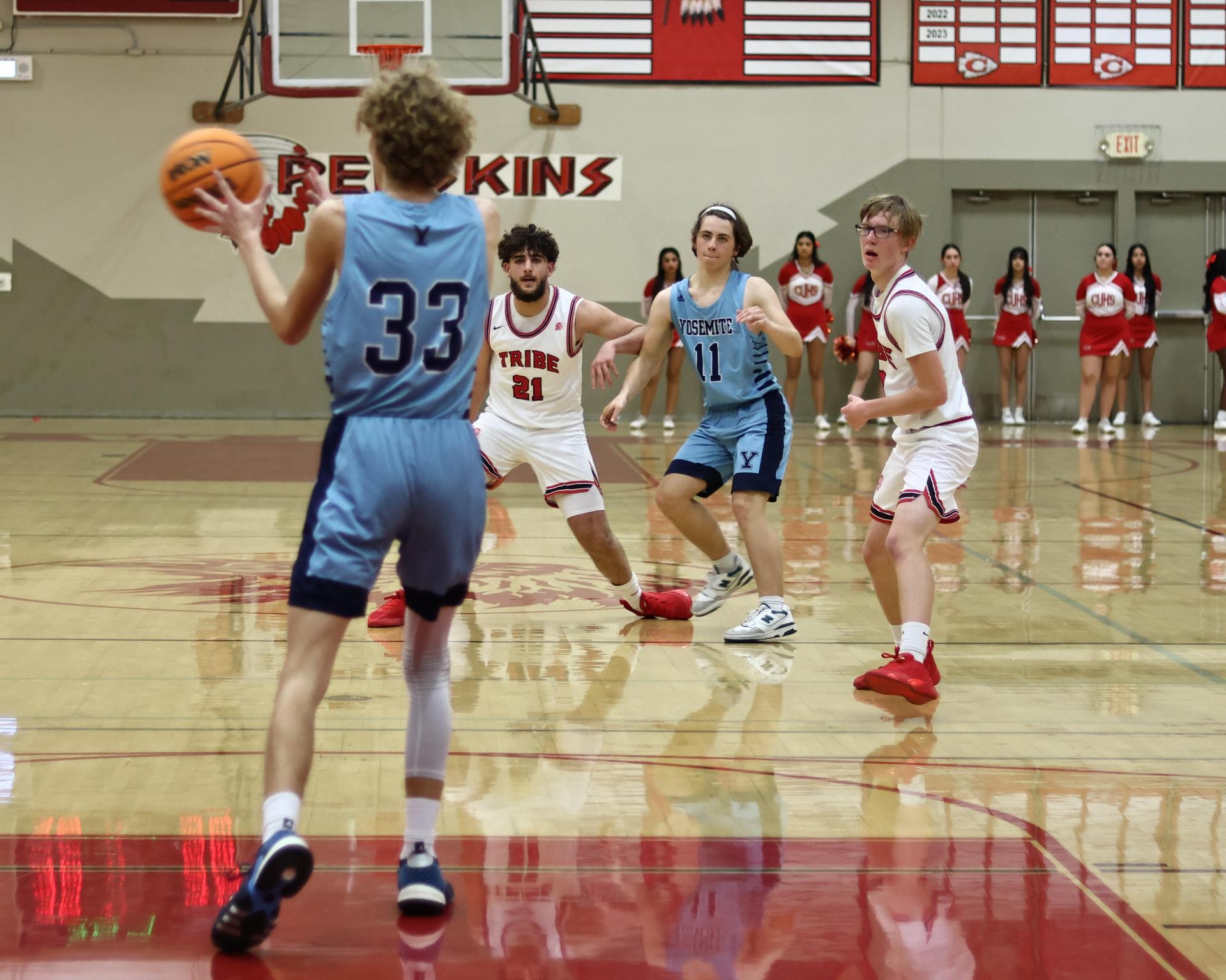 Varsity boys playing basketball against yosemite