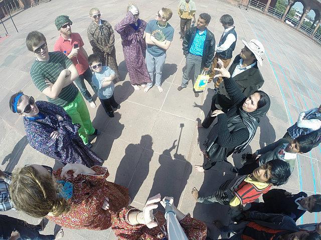 International Studies group talking with locals nearby watching