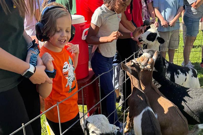 Harrison Park first-grader Nolan Muchow enjoys the petting zoo