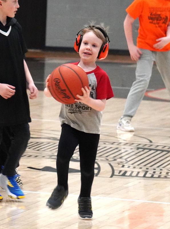 A student runs the ball up the floor.