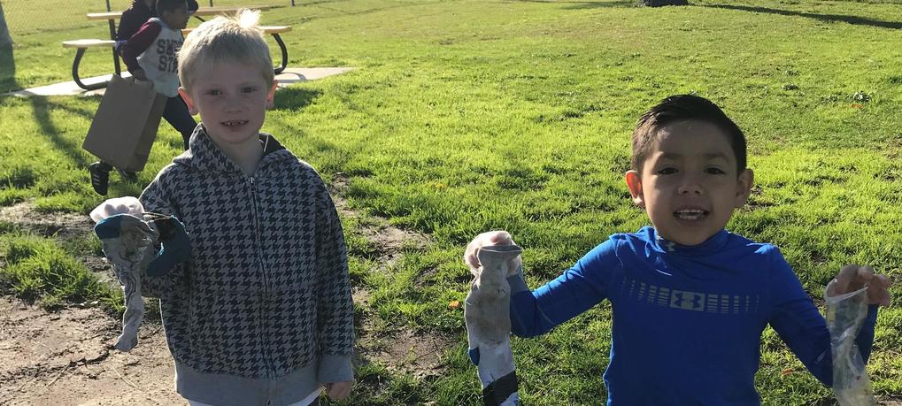 2 students cleaning up the neighborhood.