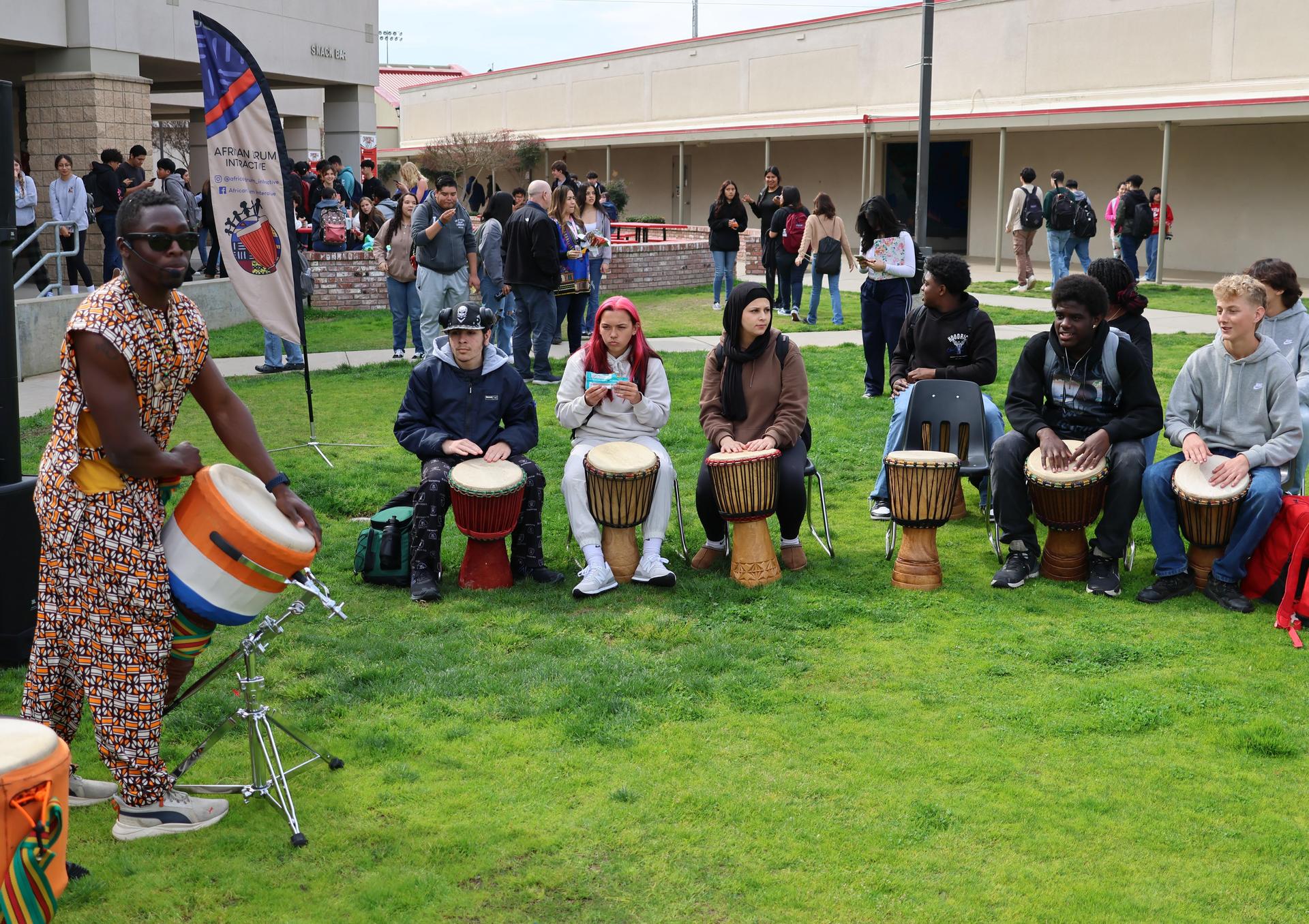 students and staff participating with the African Drum Interactive