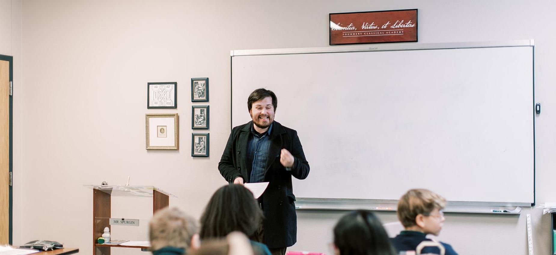 Teacher leads a lesson at the whiteboard