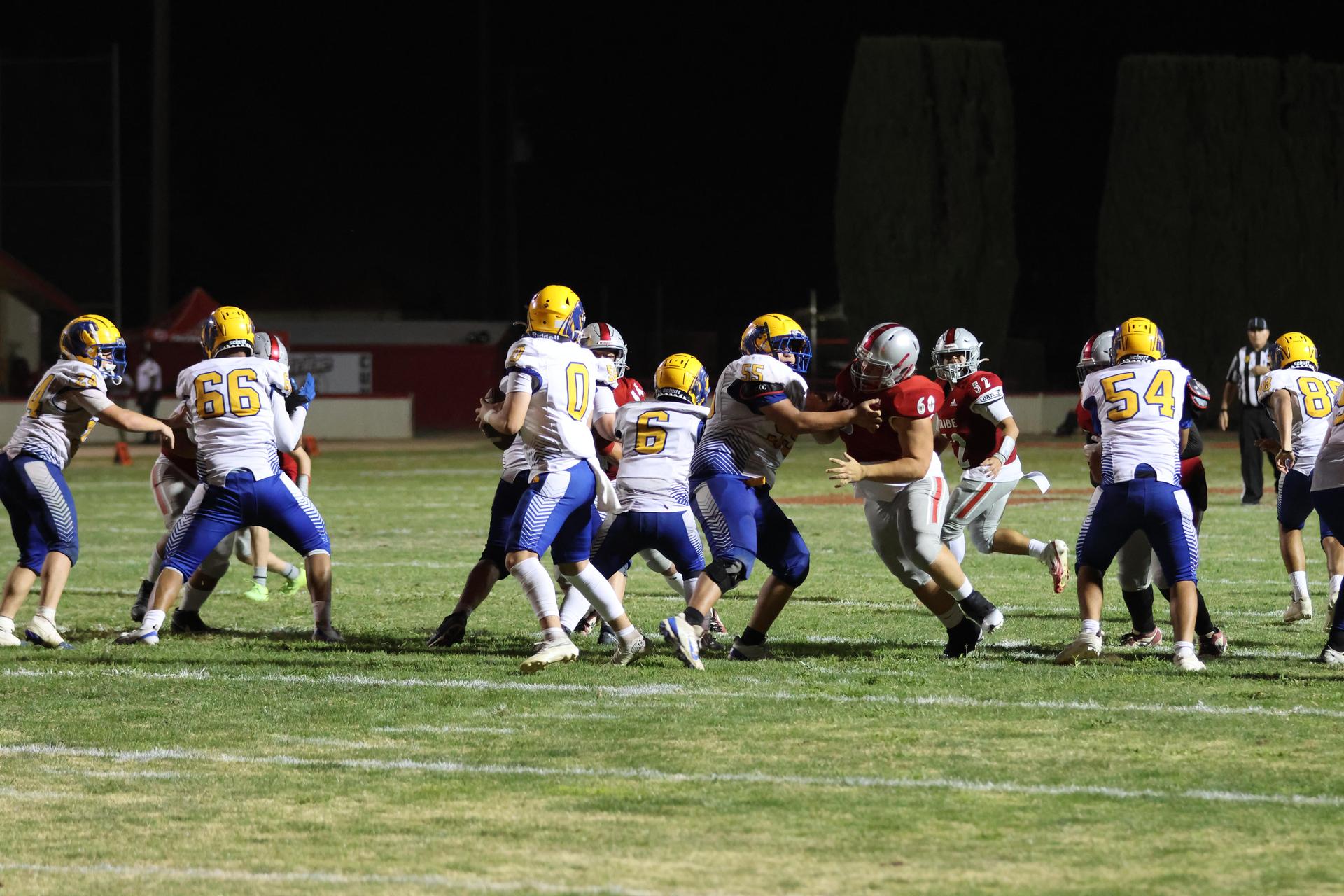 Varsity football players in action against Parlier 82