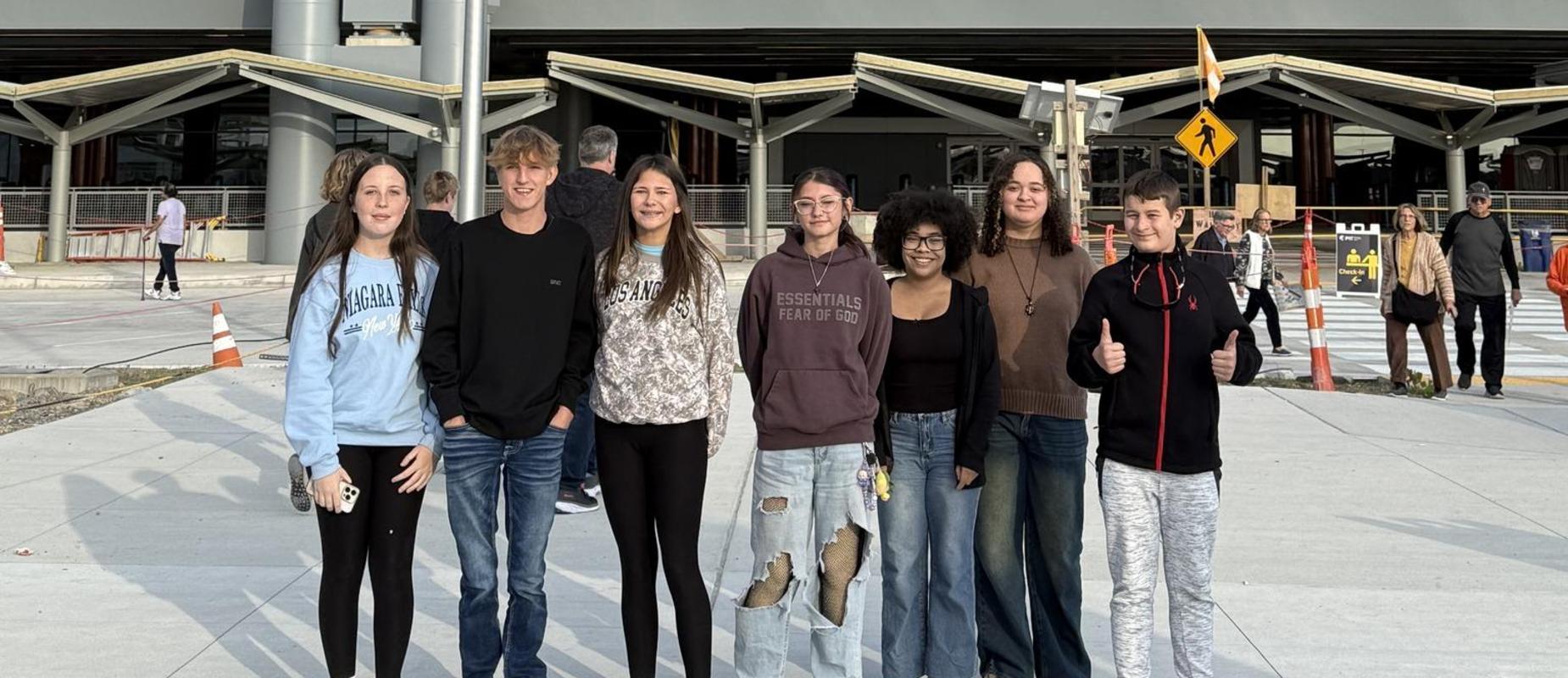 Travel club student standing infront of the new terminal at the open house event for the Pittsburgh International Airport