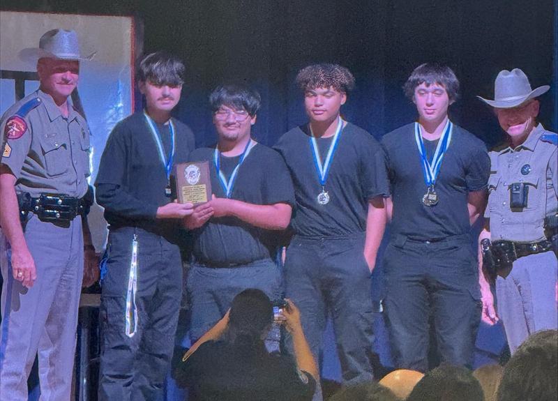 Members of the Temple HS Police Explorer SWAT Team accept their plaque