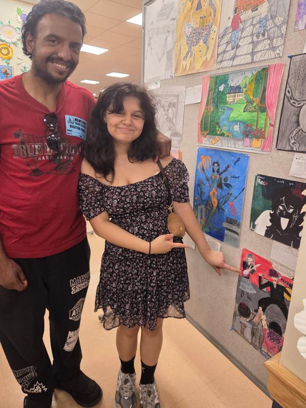 student and parent presenting art
