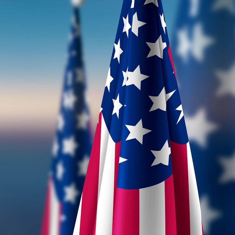 Waving American flags with red, white, and blue colors and star pattern.