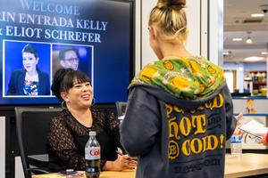 Erin Entrada Kelly signs a book for a student
