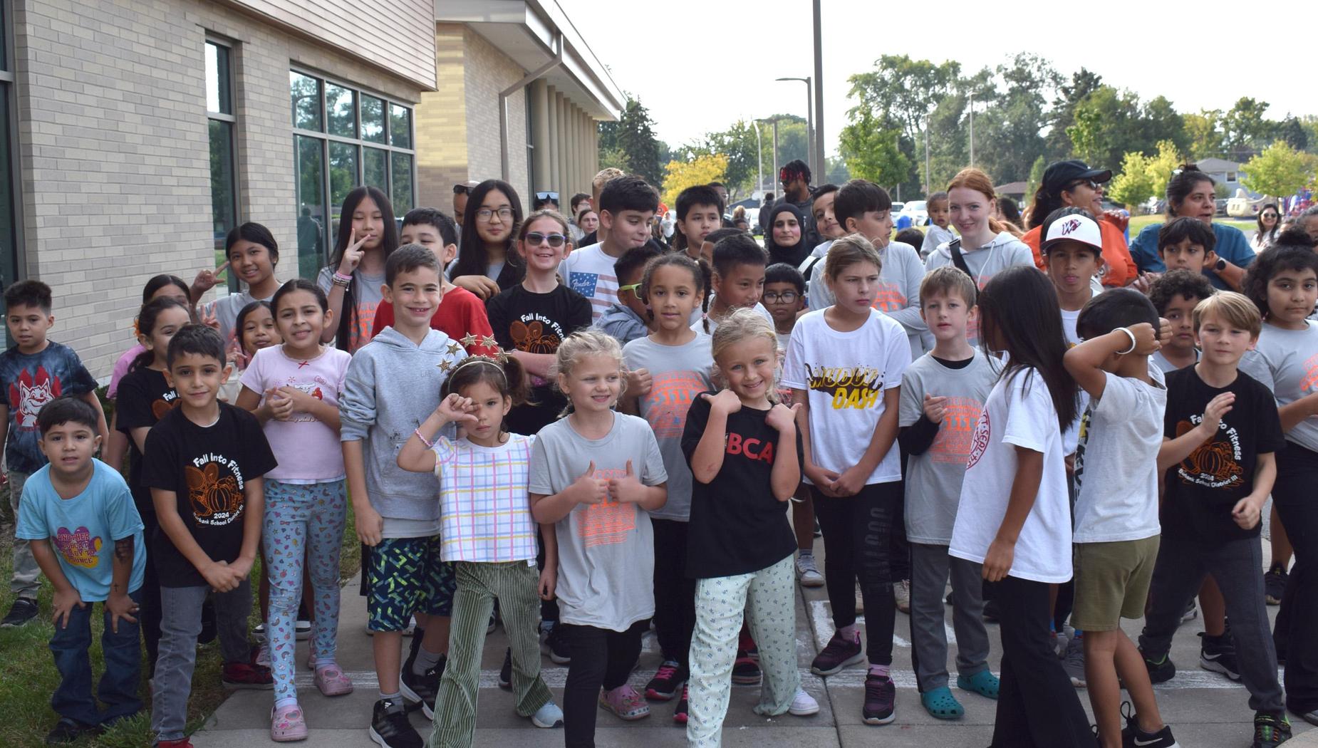 Group of children posing together outdoors for a photo.