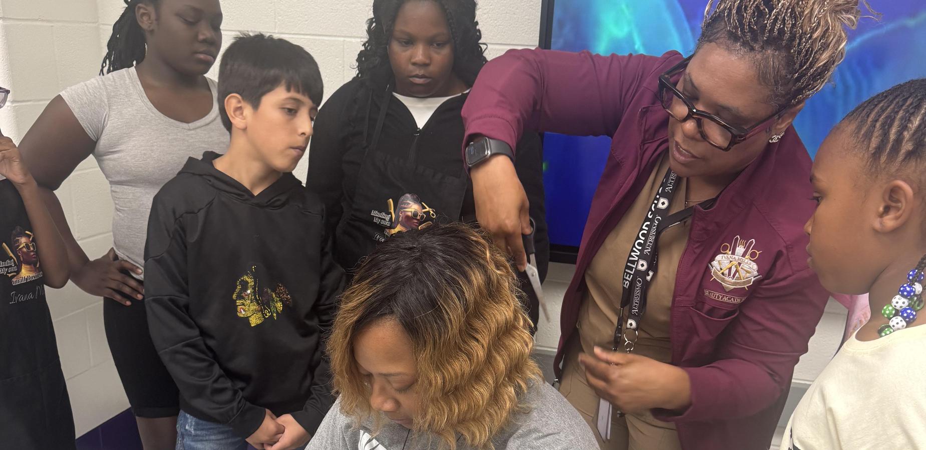 Summer school, students learning how to hairstyle.