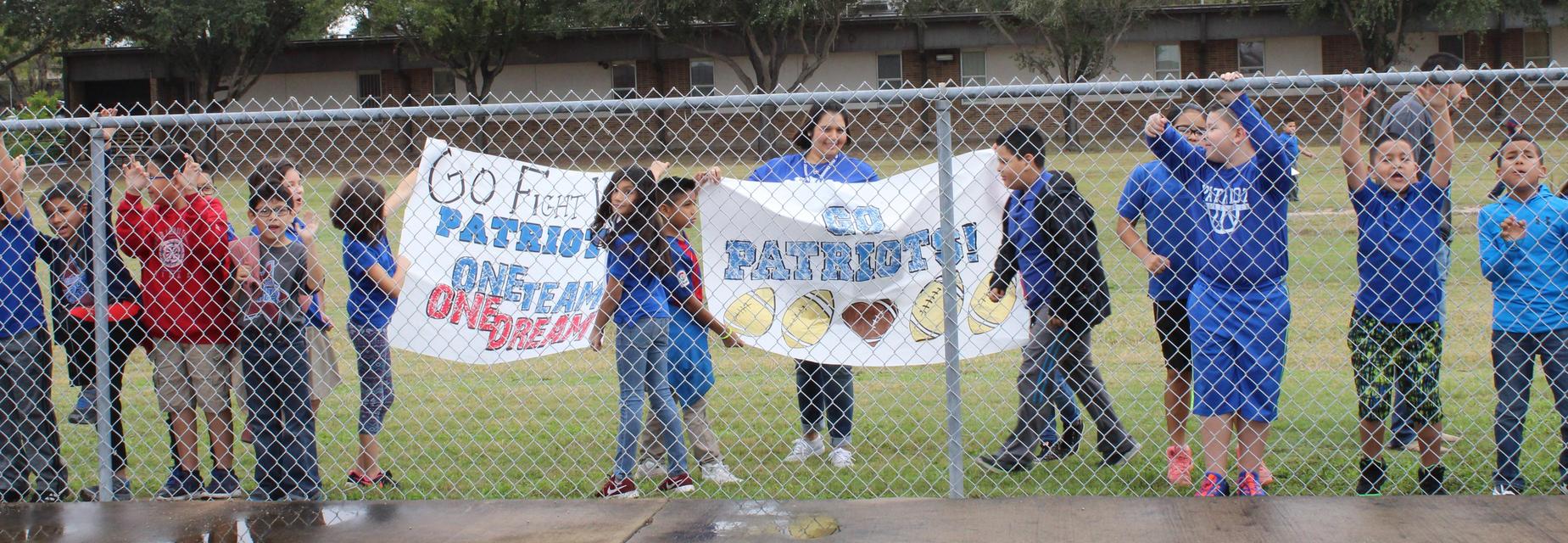 students cheering holding signs