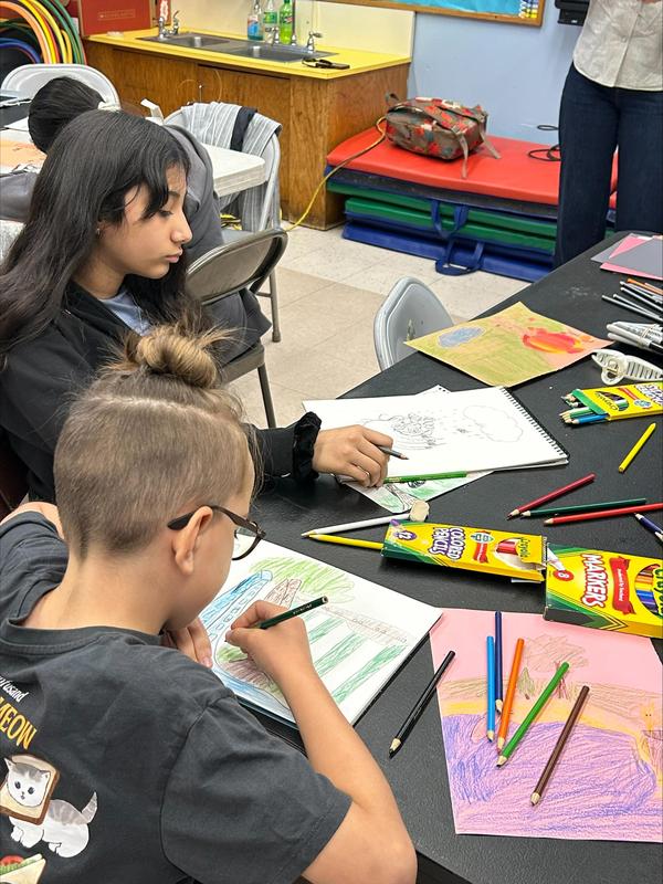 students sitting and drawing