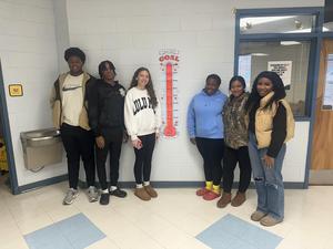 Students showing off their glow in the dark bracelets