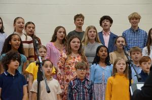 Middle School Choir members rehearse for the concert.