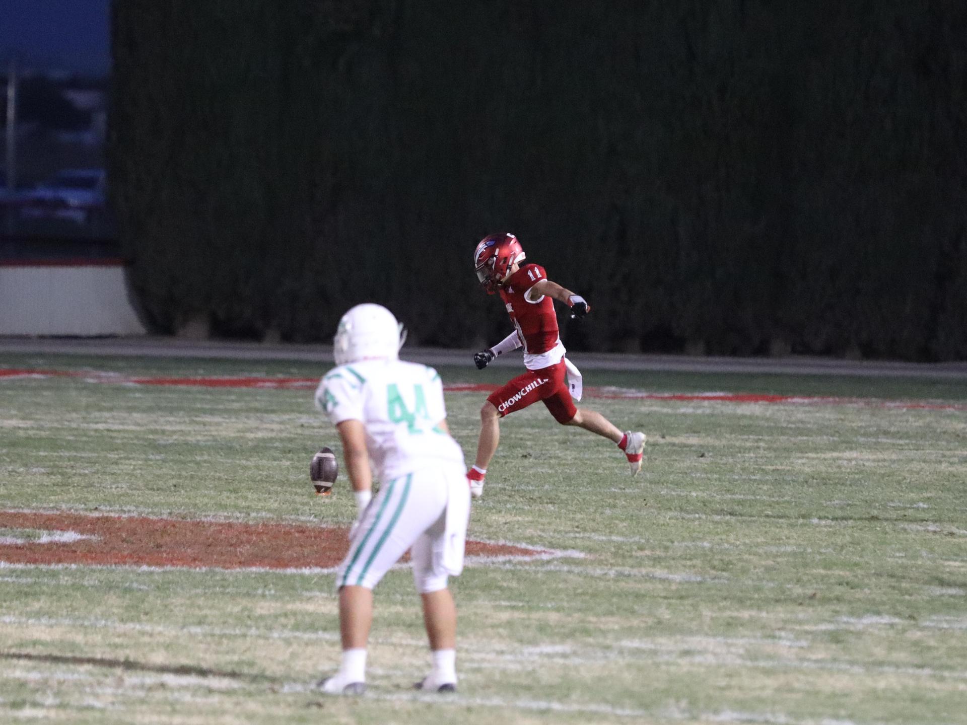 varsity football players in action against Riverdale
