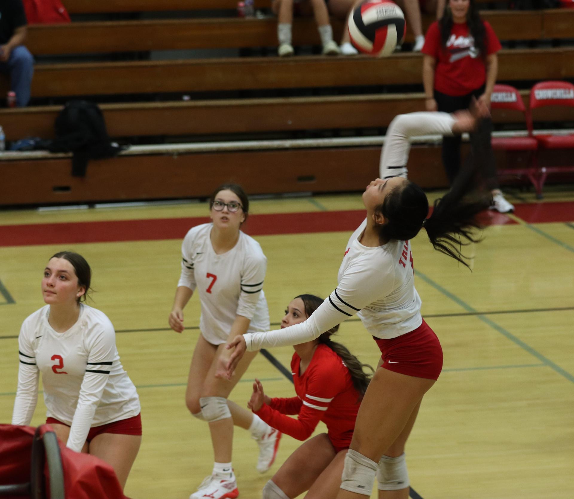 varsity volleyball players in action against liberty