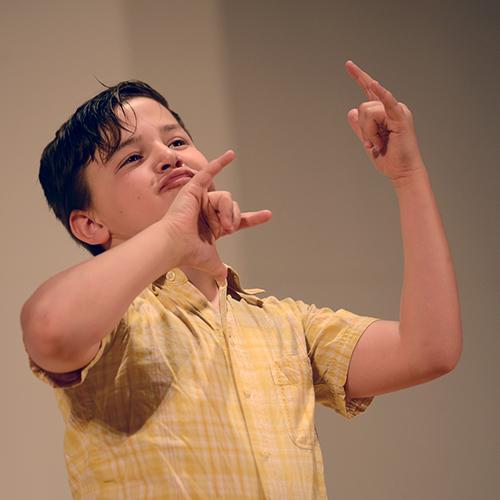 Boy signing enthusiastically