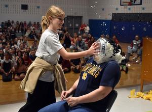 a student throwing a pie in a teacher's face