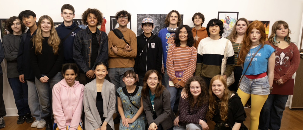 students gathered in front of artwork