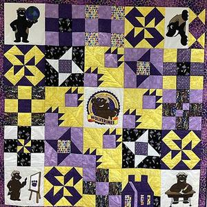 A purple and gold quilt.