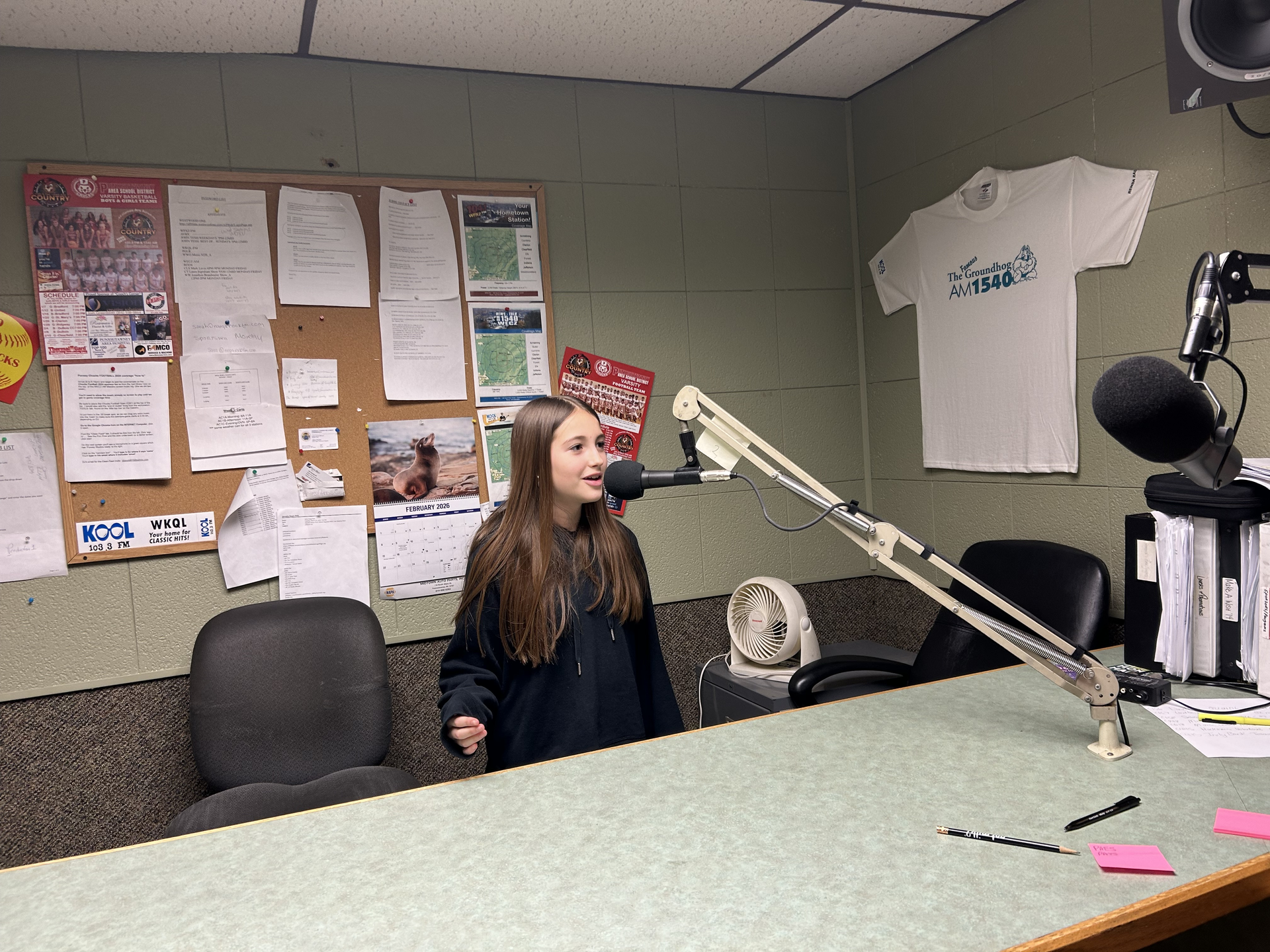 Anna Huffman talking into a microphone at the radio station